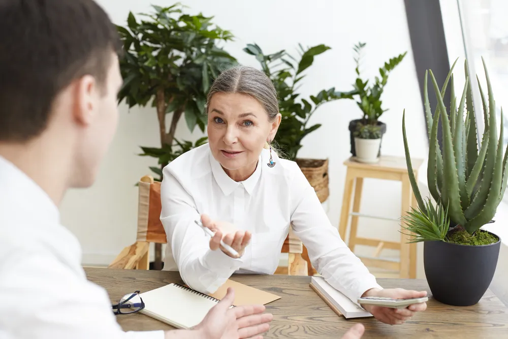 femme qui échange avec un jeune homme au travail